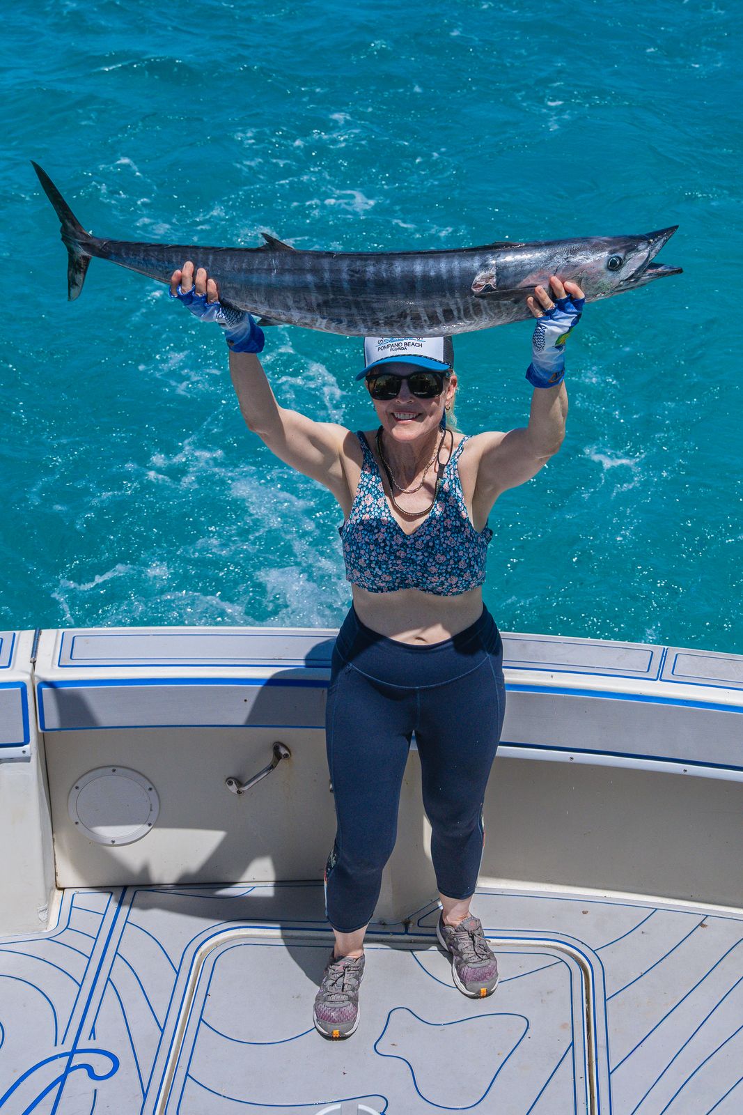 Two anglers holding a sailfish boatside before release off Islamorada