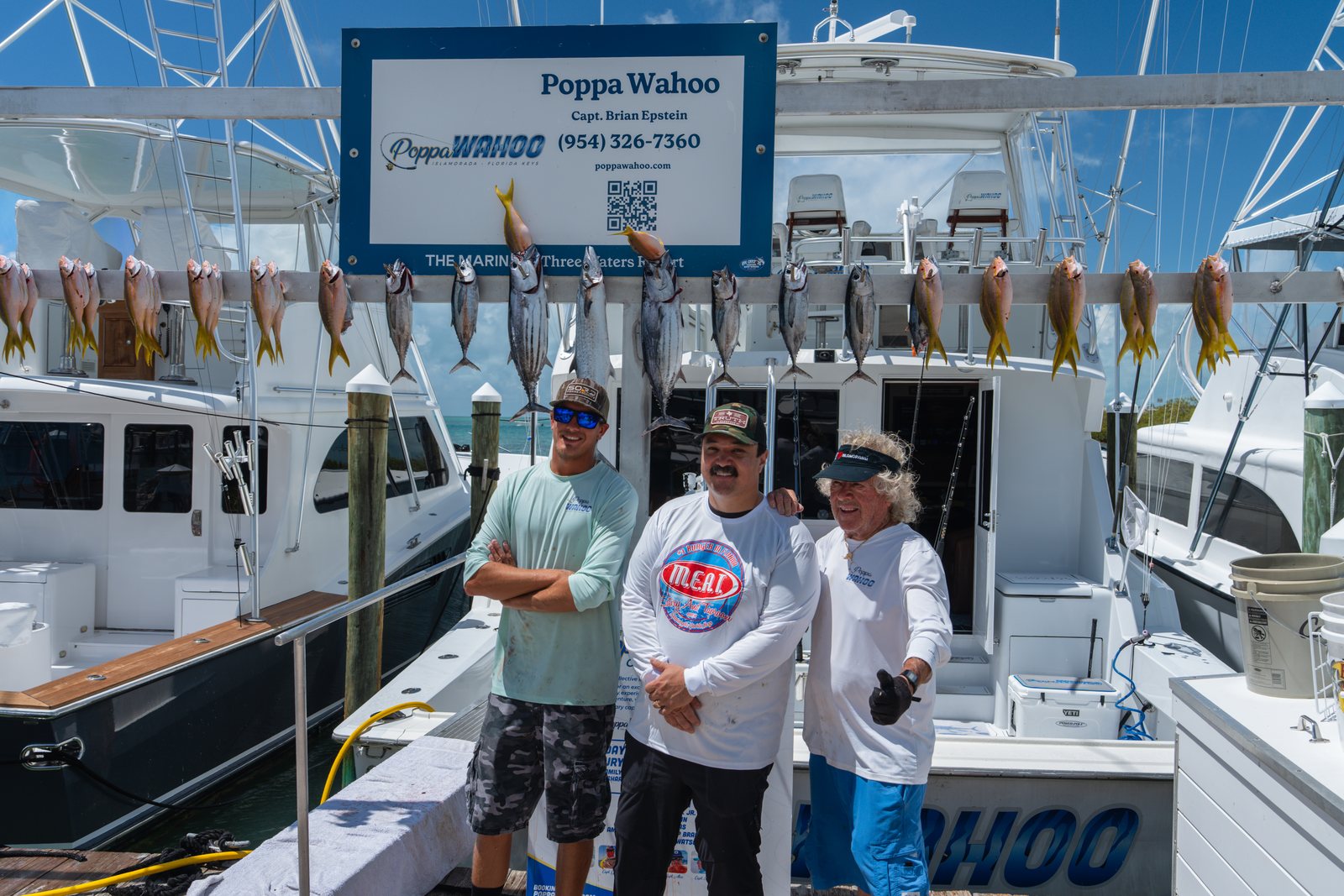Captains and crew under the dock sign