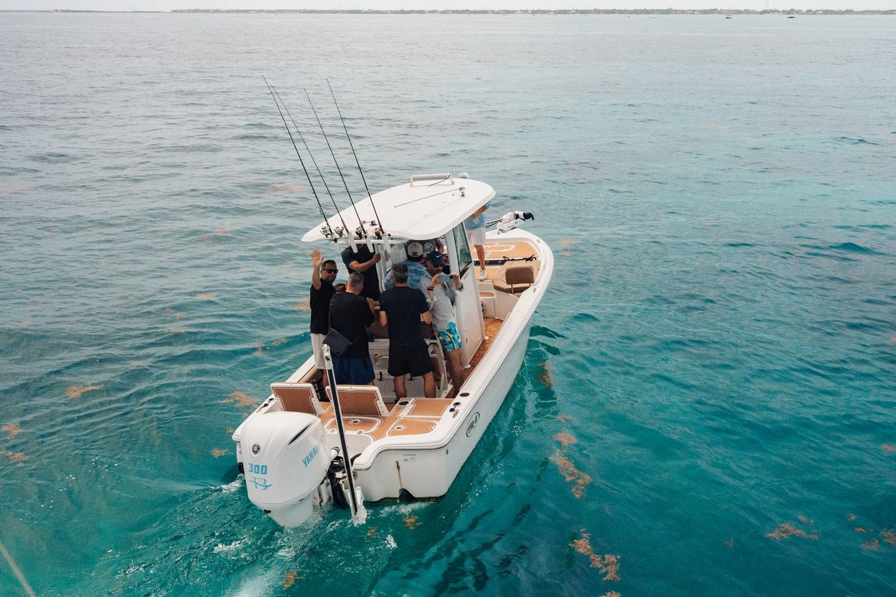 A Poppa Wahoo Collective boat anchored on clear water off Islamorada