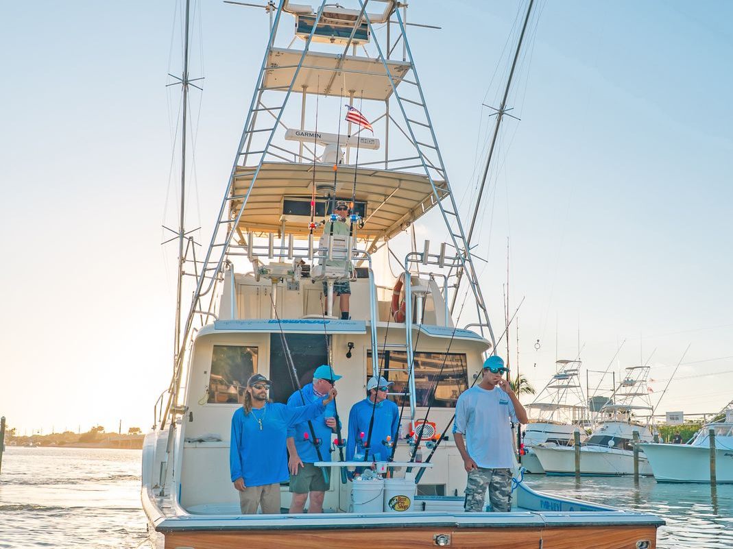 Poppa Wahoo Too at golden hour with the crew aboard at the dock
