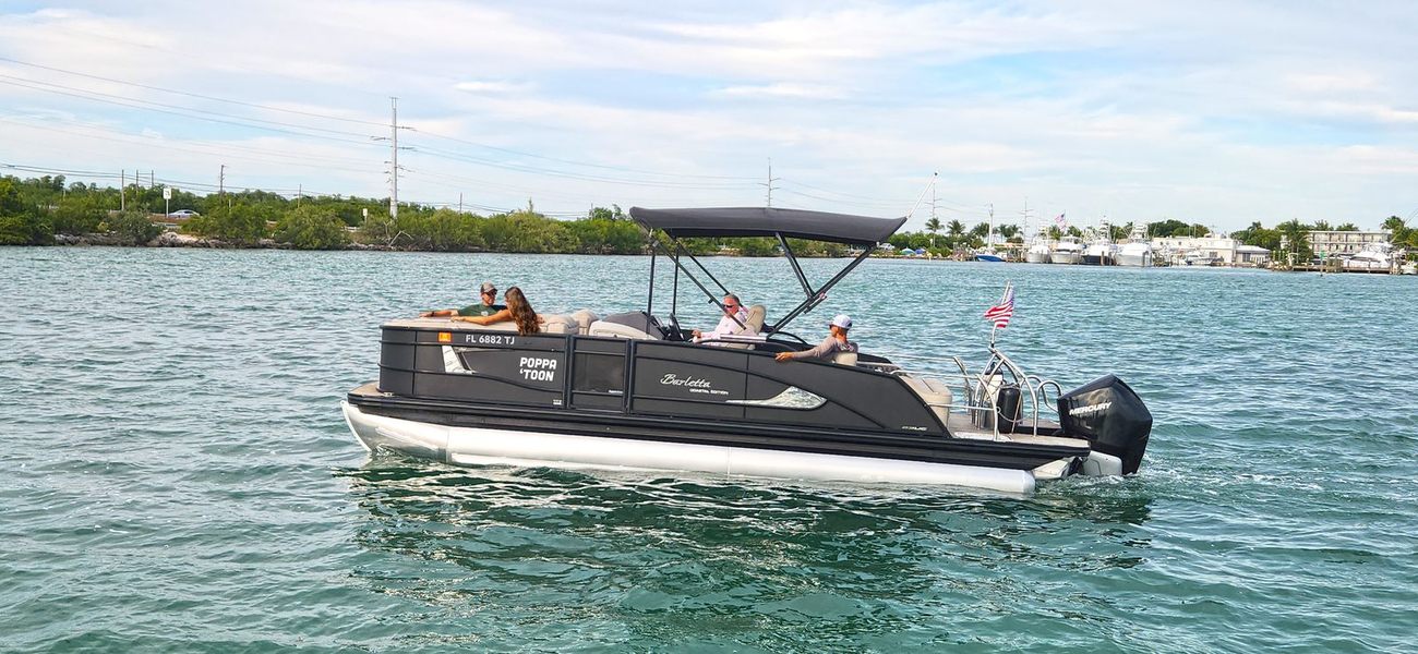 Poppa Toon cruising flat water on the way to the sandbar
