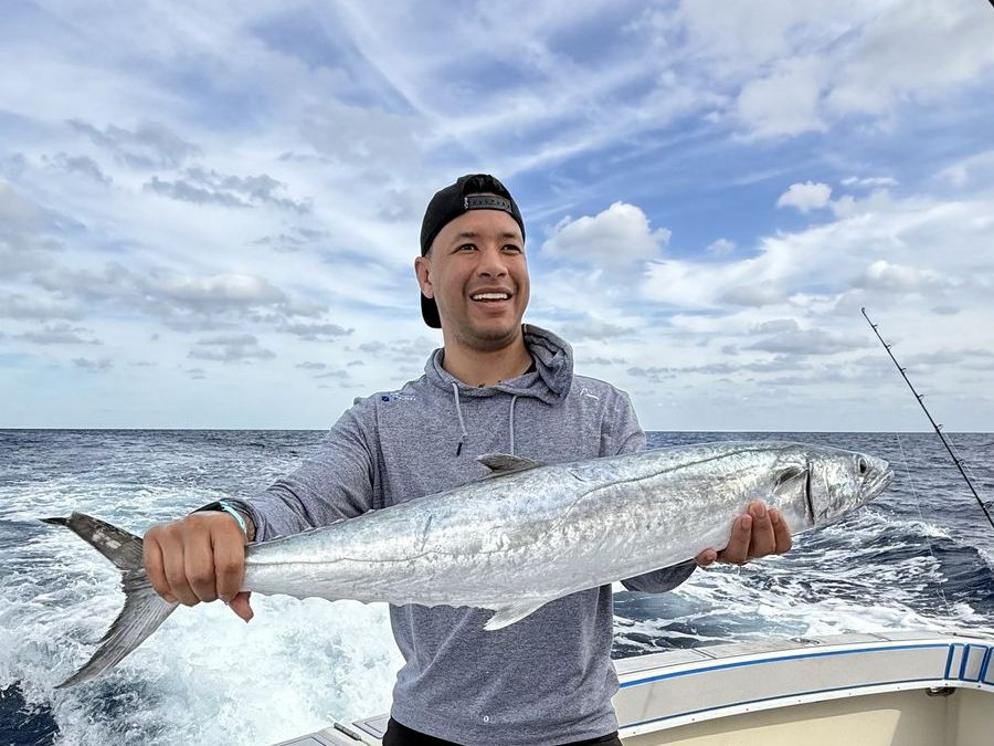 A king mackerel held on the deck of Poppa Wahoo Too