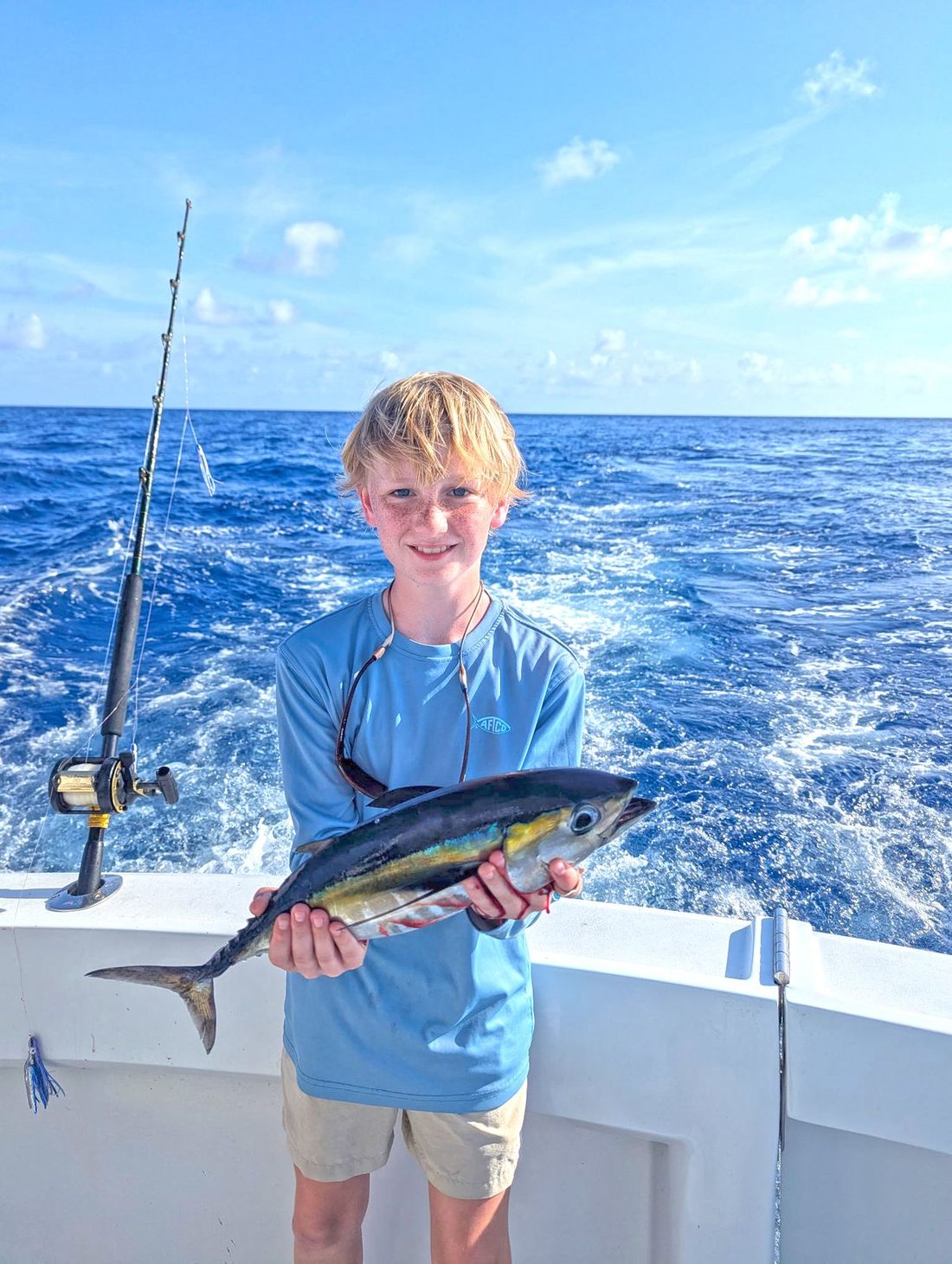 A young angler with a blackfin tuna aboard the Poppa Wahoo