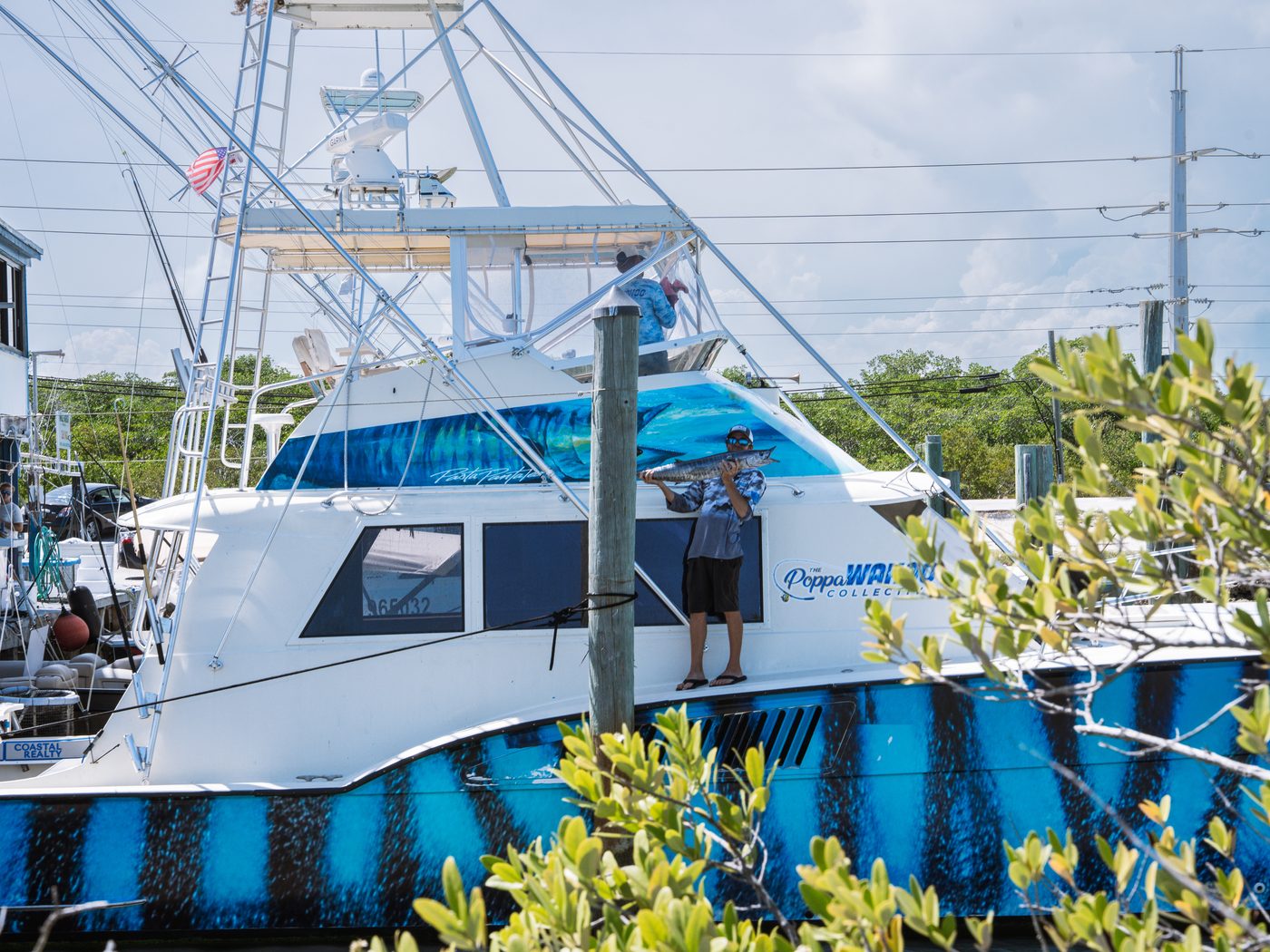 Poppa Wahoo Too, the Hatteras with the wahoo stripe hull wrap, at the dock in Islamorada